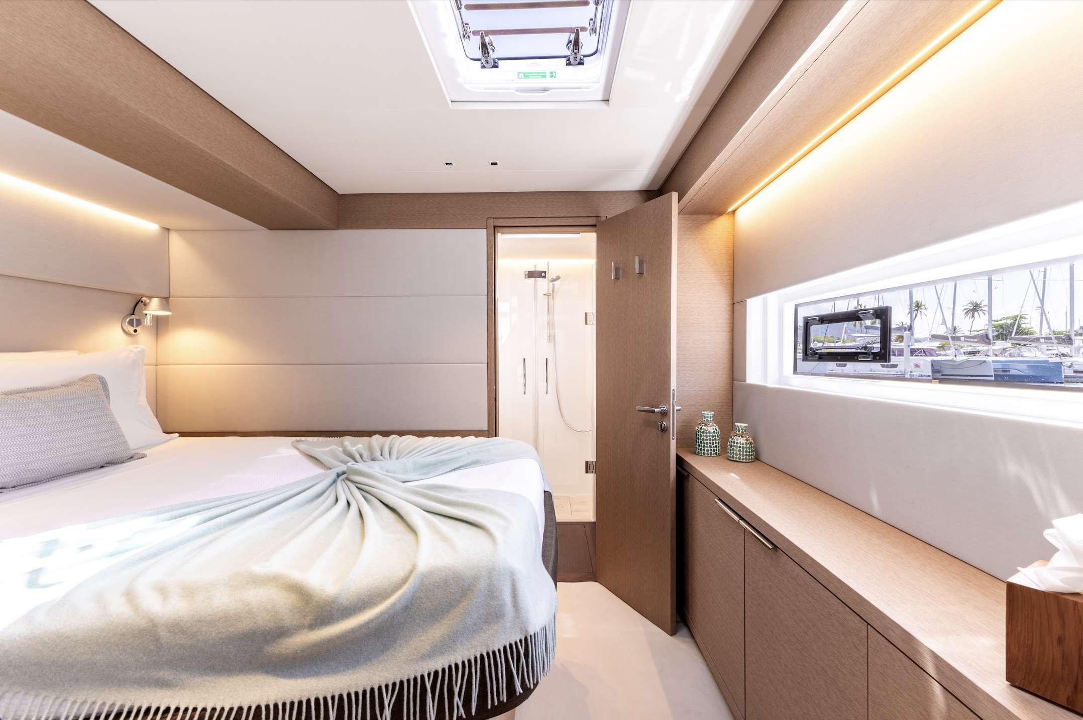 Aura Catamaran stateroom with bright lighting, and modern touches