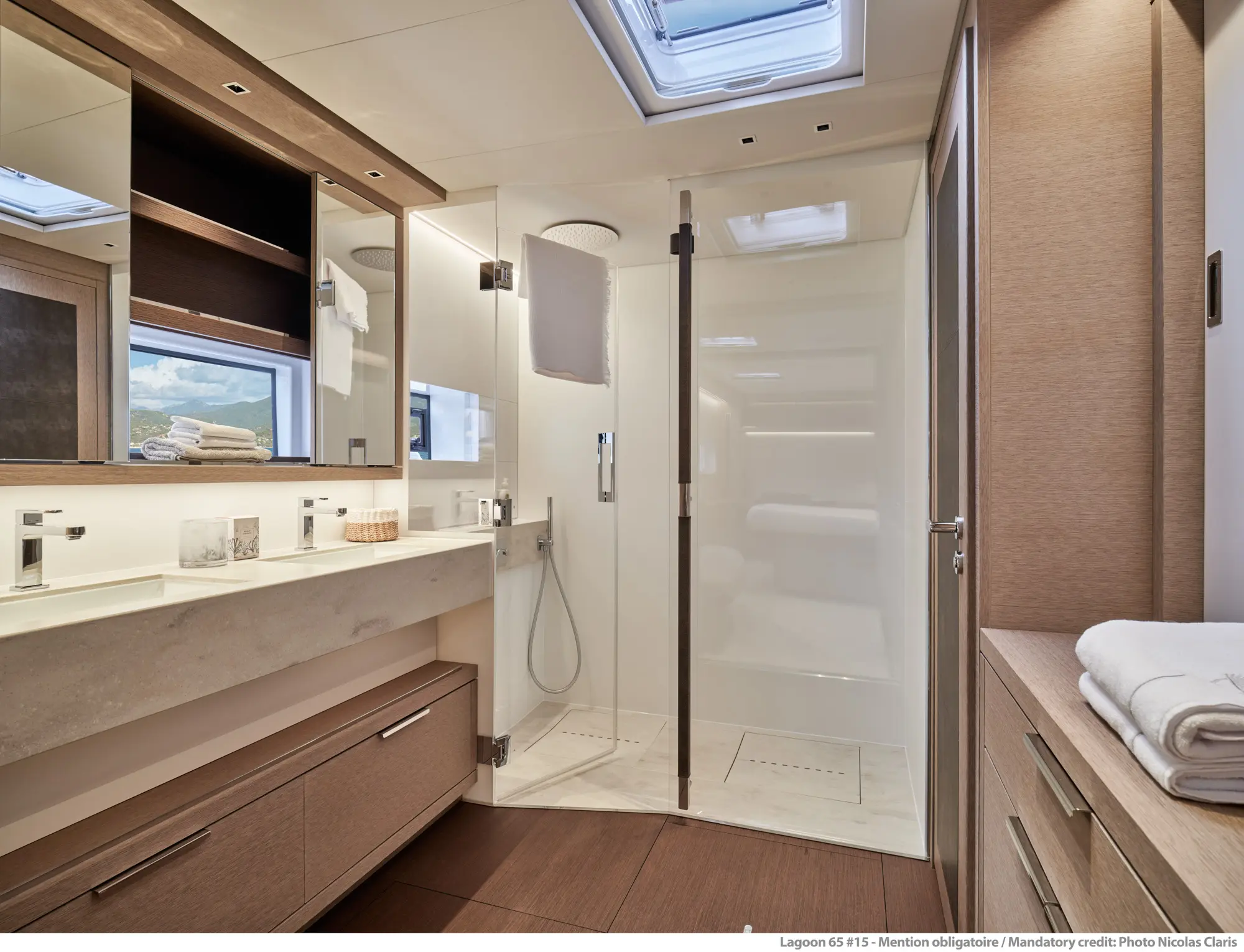 Seahome II ensuite bathroom with beautiful granite countertops, floor to ceiling glass showers, and towels
